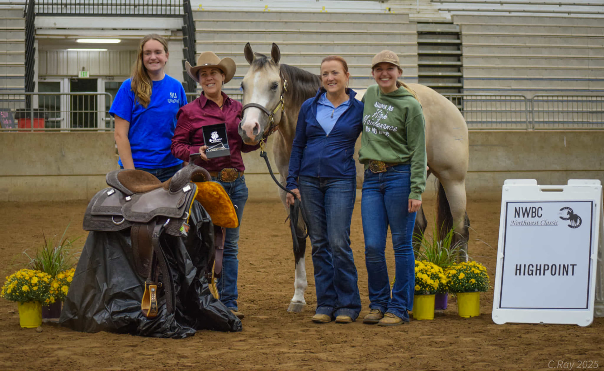 The Northern Grace team celebrating a Highpoint championship with a horse and award saddle at the Northwest Classic